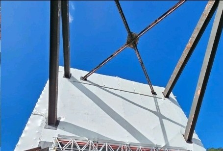 Sealed and tensioned containment wrapped around the underside of the bridge structure