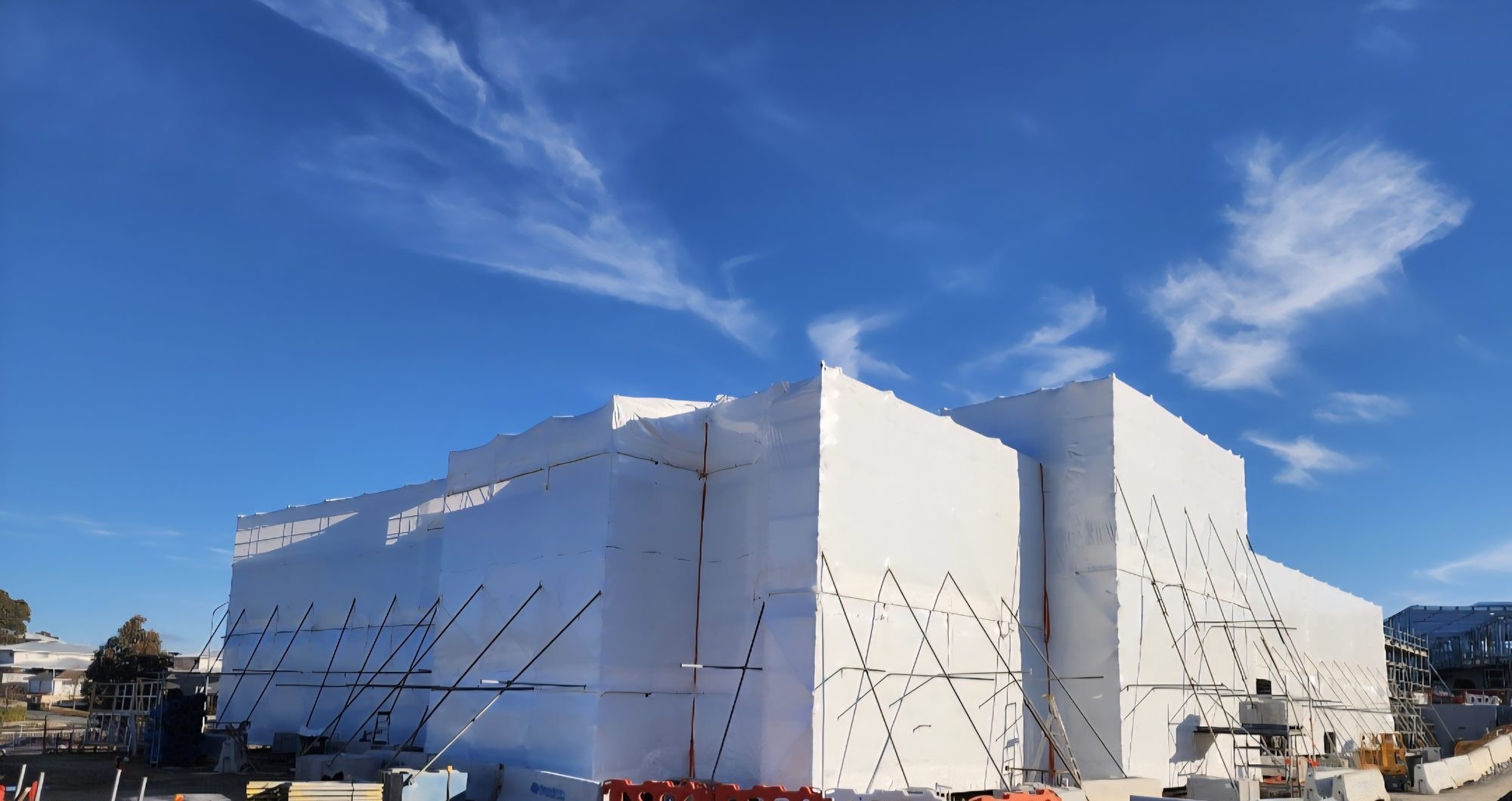 Full building shrink wrap encapsulation over perimeter scaffold on a school development in Canberra
