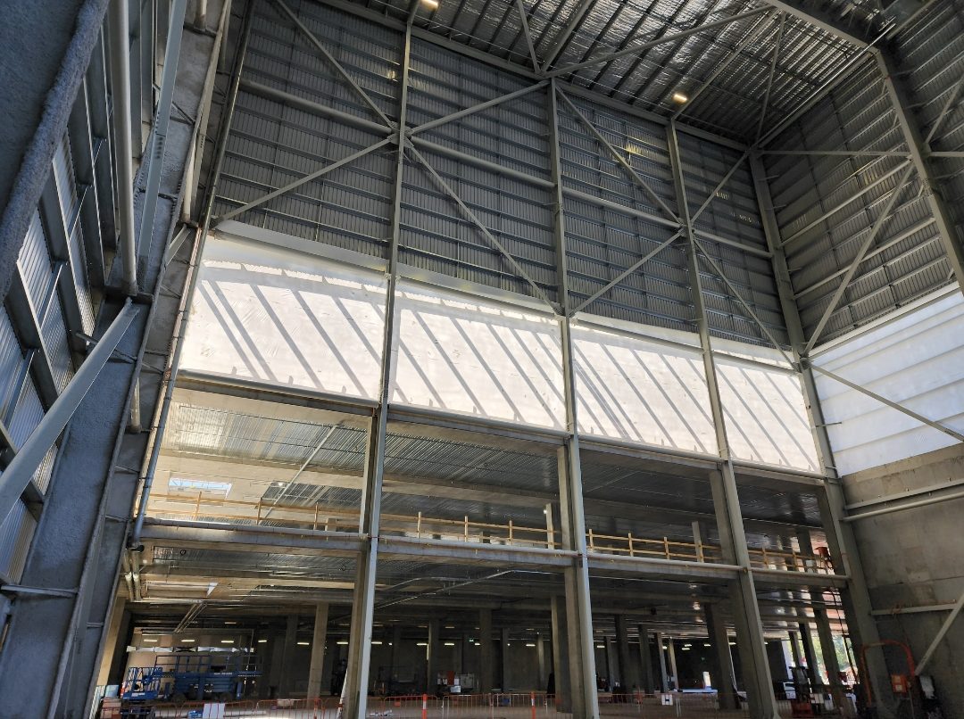 Interior view of the high bay showing the enclosed upper elevation above the working floor