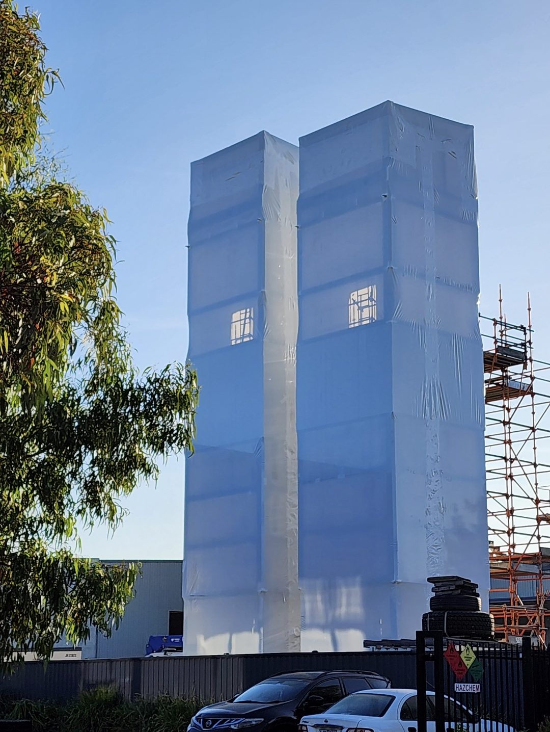 Twin lift shafts fully encapsulated in shrink wrap on a rail upgrade project in Victoria